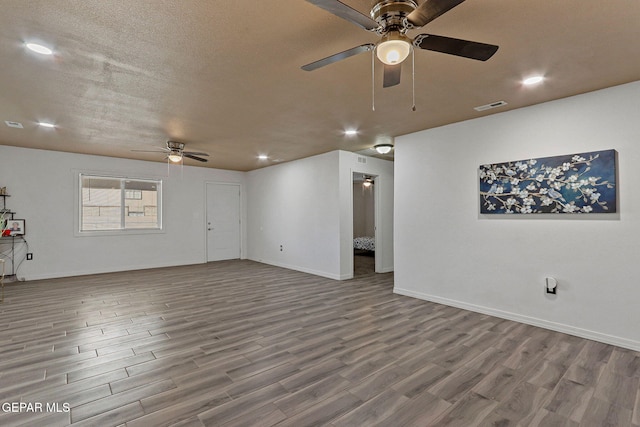 unfurnished living room with a textured ceiling, ceiling fan, and hardwood / wood-style flooring