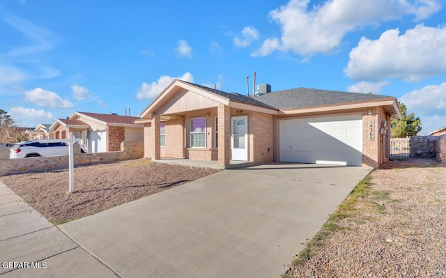 single story home featuring covered porch and a garage