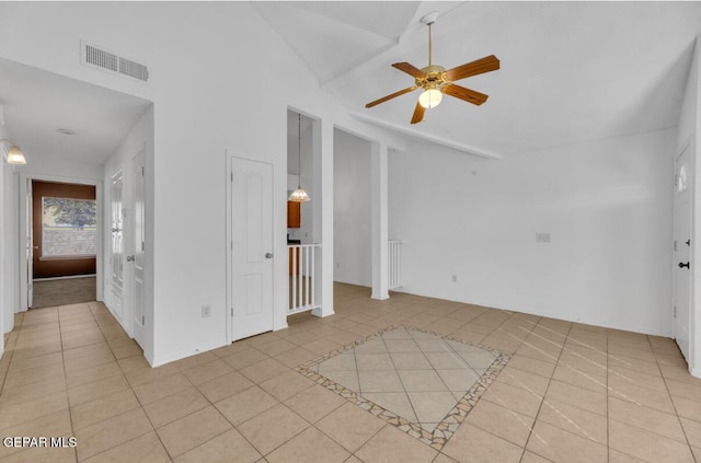 unfurnished living room with ceiling fan, light tile patterned floors, and lofted ceiling