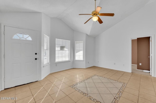 entryway with ceiling fan, light tile patterned floors, and lofted ceiling