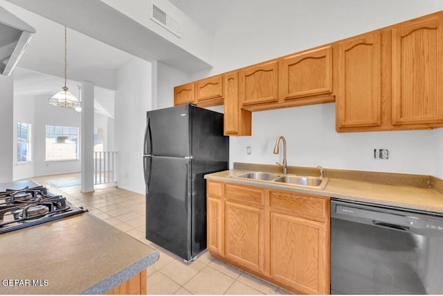 kitchen with decorative light fixtures, a notable chandelier, black appliances, sink, and light tile patterned floors