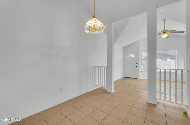 tiled spare room with ceiling fan with notable chandelier and vaulted ceiling