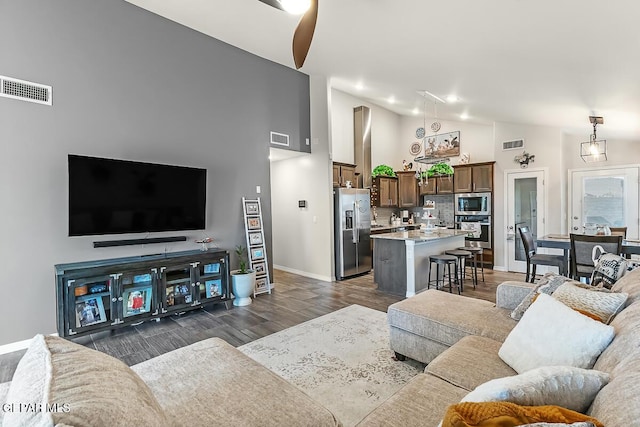 living room featuring ceiling fan and lofted ceiling