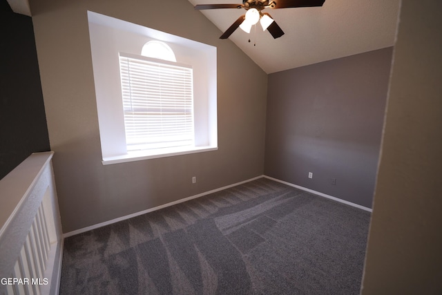 carpeted spare room featuring ceiling fan and lofted ceiling