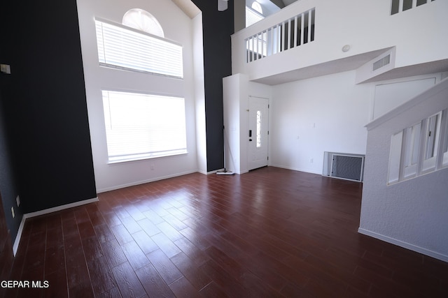 interior space with dark hardwood / wood-style floors and a high ceiling