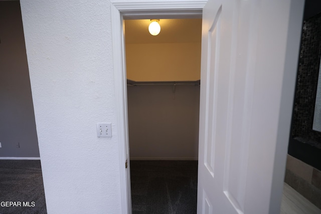 interior space featuring dark colored carpet