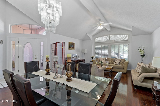 dining area featuring ceiling fan with notable chandelier, lofted ceiling with beams, a textured ceiling, and wood finished floors