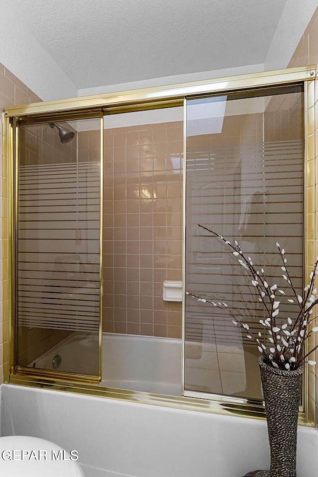 full bath featuring enclosed tub / shower combo and a textured ceiling