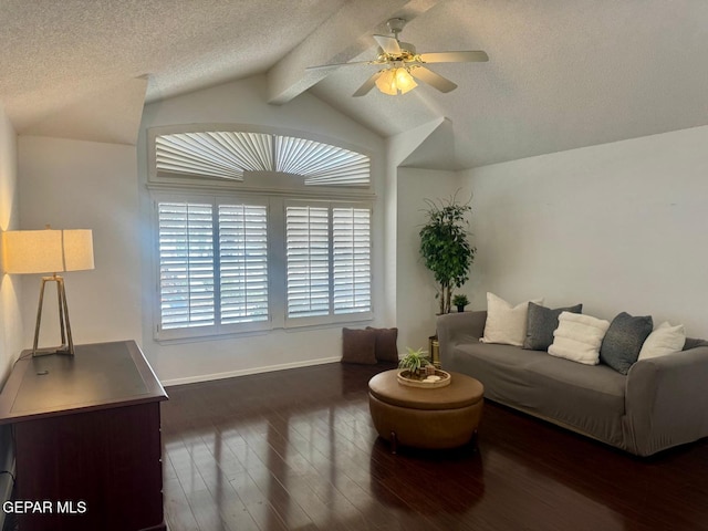 living area with a textured ceiling, ceiling fan, lofted ceiling with beams, wood finished floors, and baseboards