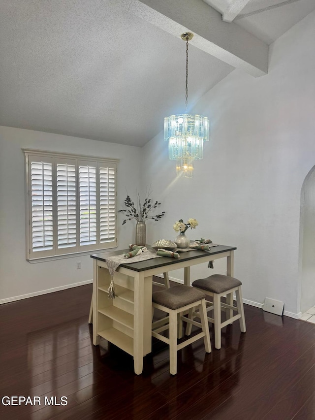 dining space with arched walkways, vaulted ceiling with beams, a notable chandelier, dark wood-style flooring, and baseboards