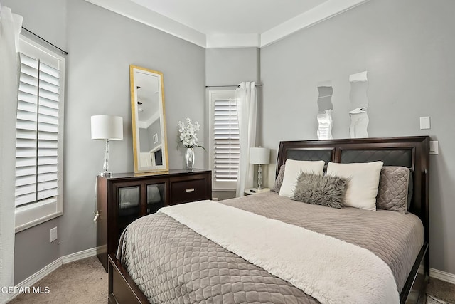 bedroom with multiple windows and carpet flooring