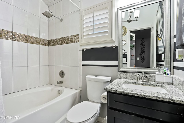 full bathroom featuring toilet, vanity, and tiled shower / bath combo