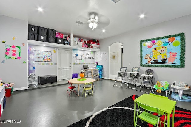 playroom with concrete floors and ceiling fan