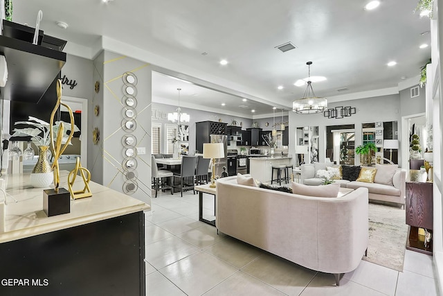 living room featuring light tile patterned flooring and a chandelier