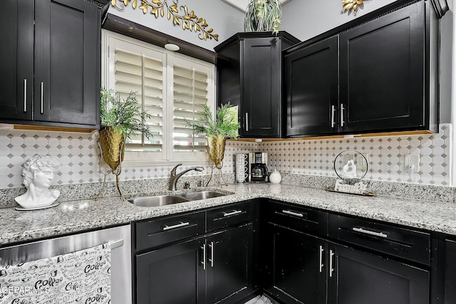 kitchen featuring light stone countertops, dishwasher, backsplash, and sink