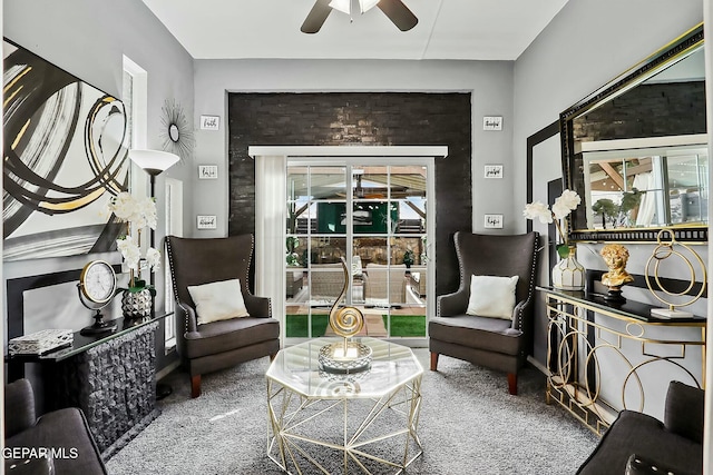 living area featuring ceiling fan and carpet