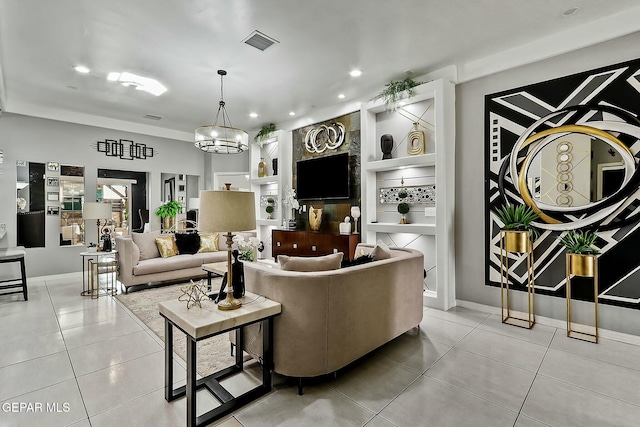 tiled living room featuring built in features and a notable chandelier