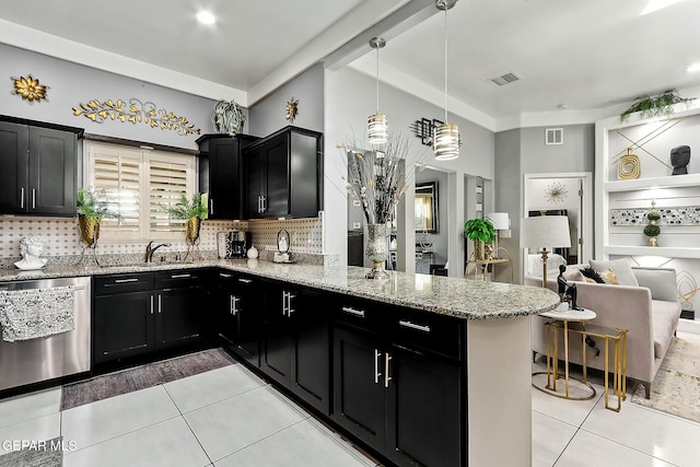 kitchen with pendant lighting, backsplash, kitchen peninsula, light stone counters, and stainless steel dishwasher