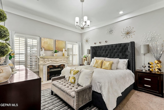 bedroom with a premium fireplace and a chandelier