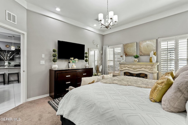 carpeted bedroom with a notable chandelier