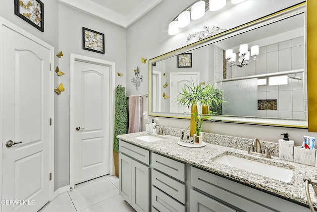 bathroom featuring a chandelier, crown molding, tile patterned floors, and vanity