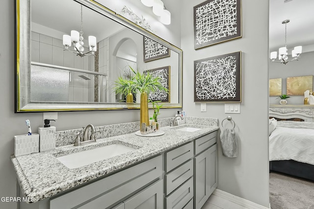 bathroom with vanity and a chandelier