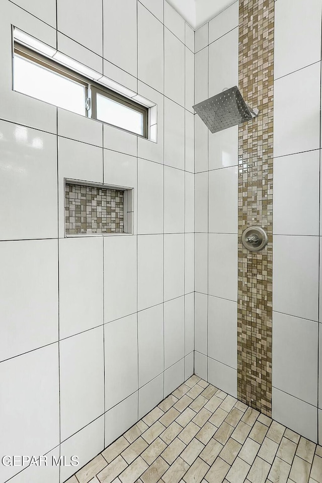 bathroom with a tile shower