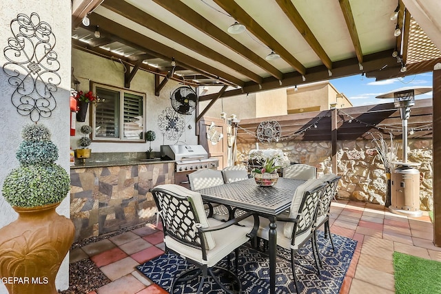 view of patio featuring an outdoor kitchen, water heater, and a grill