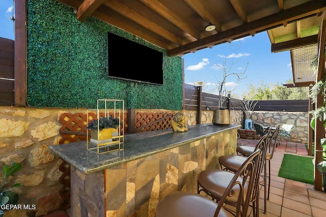 view of patio with an outdoor bar