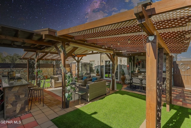 view of patio featuring exterior bar, an outdoor living space, and a pergola