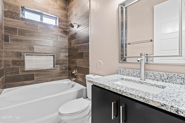 full bathroom with toilet, vanity, and tiled shower / bath combo