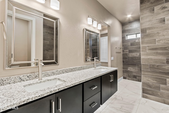 bathroom with vanity and tiled shower