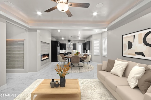 living room featuring ceiling fan and a fireplace