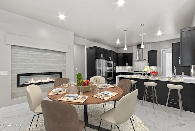 dining room featuring a fireplace and sink