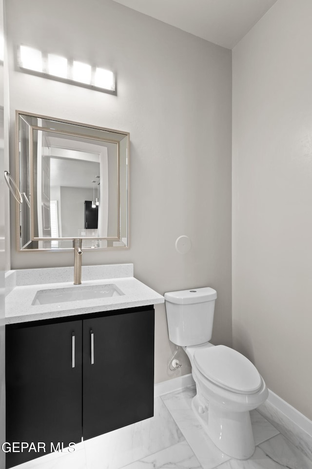 bathroom featuring toilet and vanity