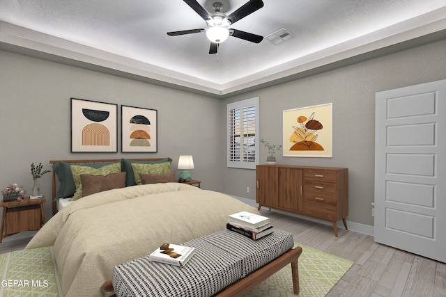 bedroom with ceiling fan and light hardwood / wood-style flooring