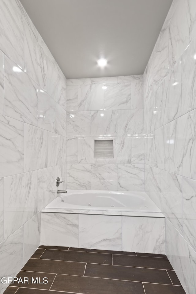 bathroom with tiled bath