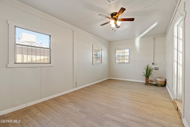 spare room with ceiling fan, a healthy amount of sunlight, and light hardwood / wood-style flooring