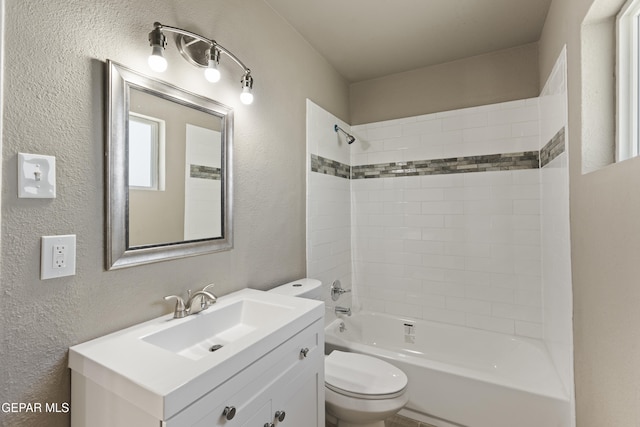 full bathroom with toilet, tiled shower / bath, and vanity