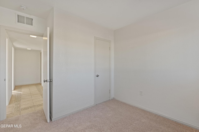 unfurnished bedroom with light carpet