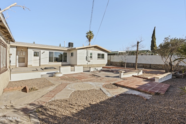 rear view of house featuring central AC unit and a patio area