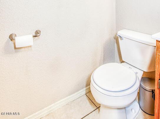 bathroom featuring toilet, vanity, and tile patterned flooring