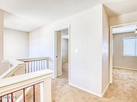 unfurnished bedroom with light carpet and a textured ceiling