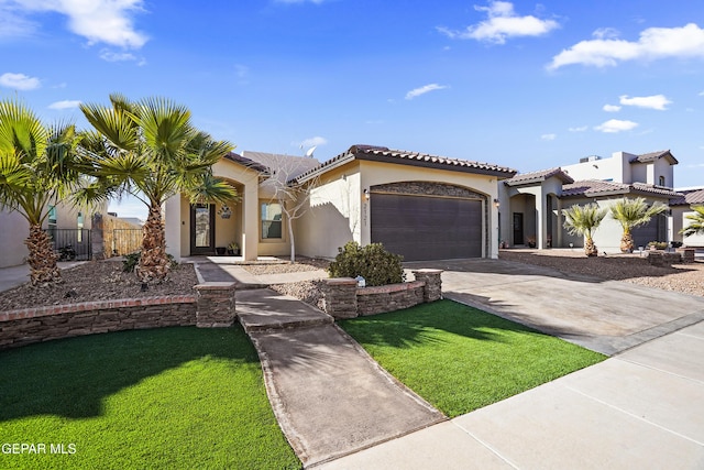 mediterranean / spanish home with a front yard and a garage