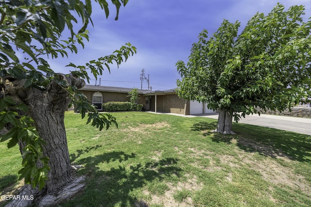 view of front of home with a front lawn and a garage