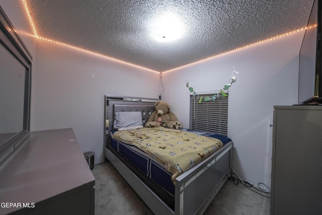 bedroom featuring a textured ceiling and light carpet