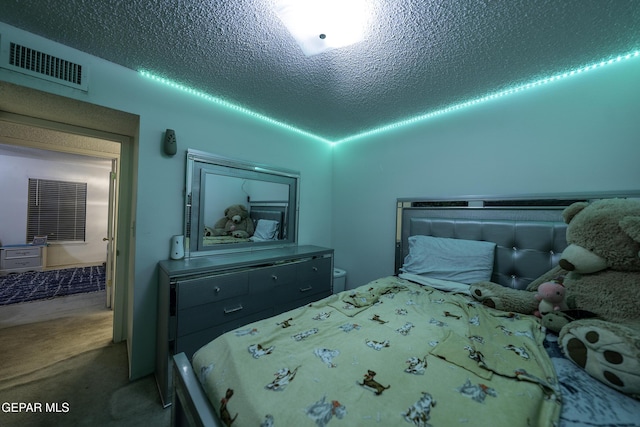 bedroom with a textured ceiling and carpet