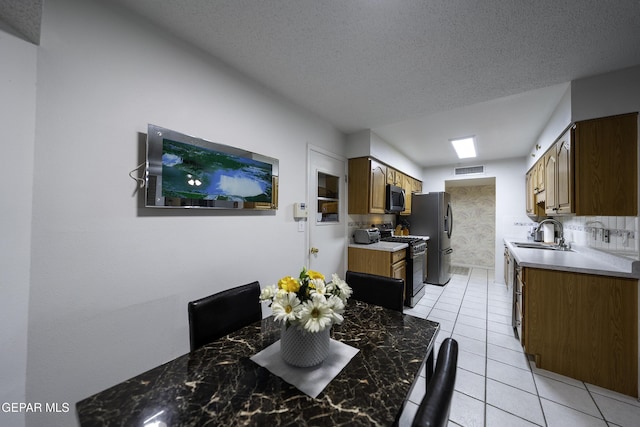 interior space with a textured ceiling and sink