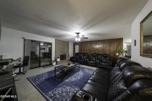 carpeted living room featuring wooden walls and a textured ceiling