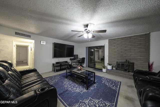 living room featuring ceiling fan and a textured ceiling